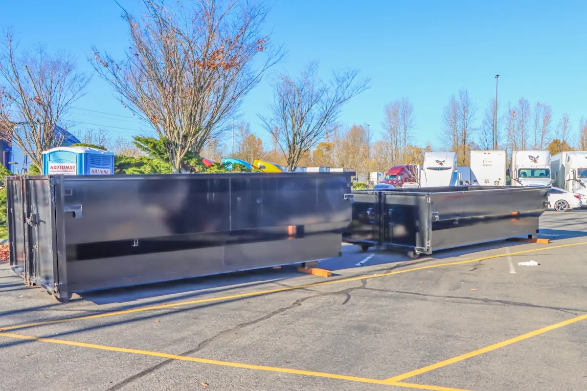 Professional dumpster rental service with roll-off container on residential driveway in Mountain Home